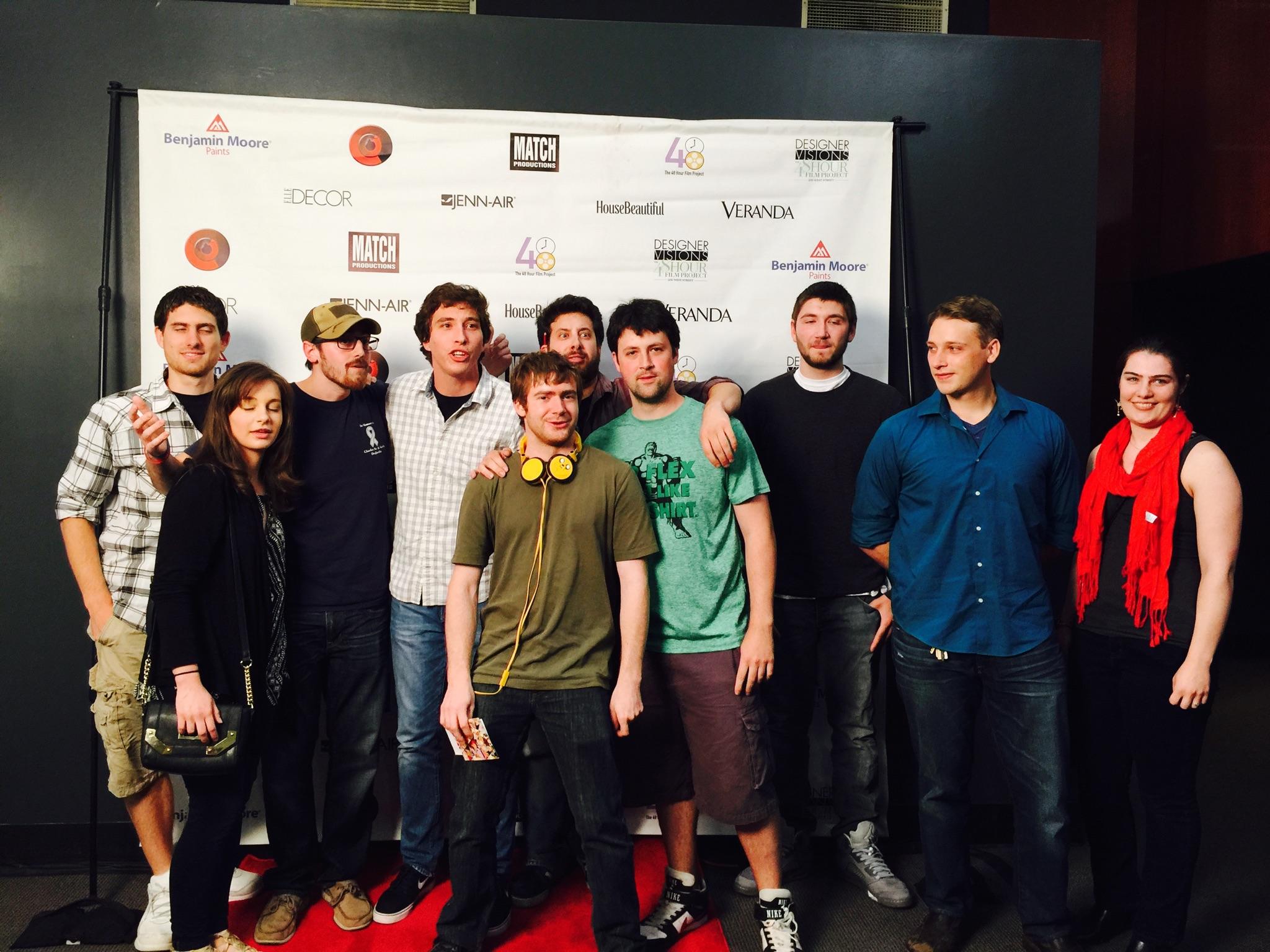 Group of students in front of a step and repeat for a campus event or organization activity